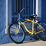 Yellow and Blue bike on a blue wall